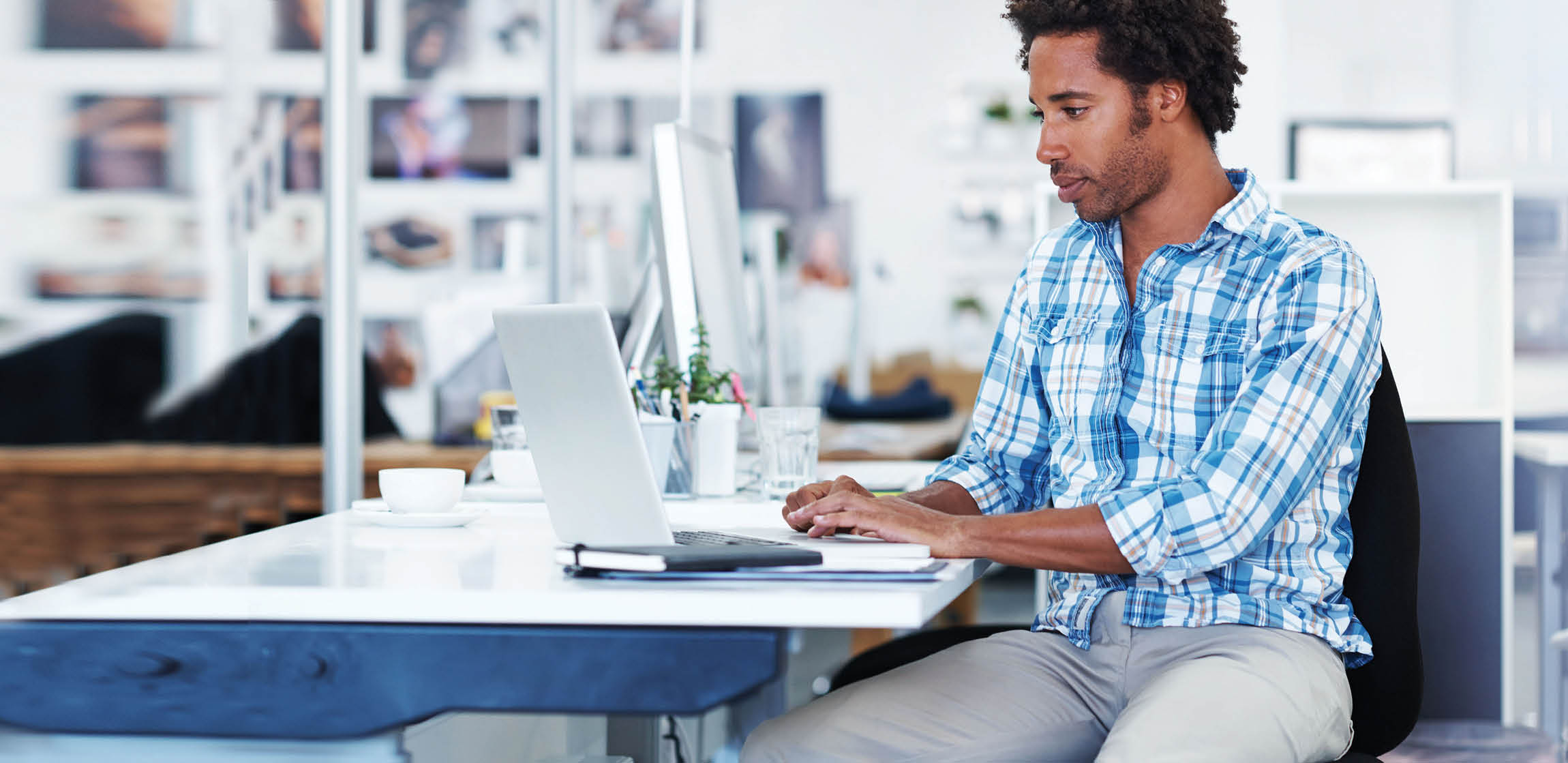 Shot of a handsome young designer working at his office desk