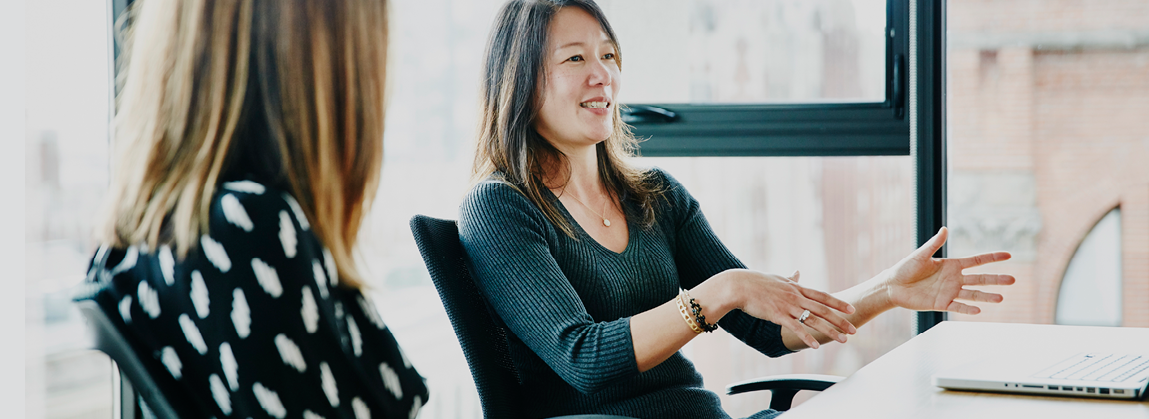 Businesswoman leading discussion during meeting in office conference room
