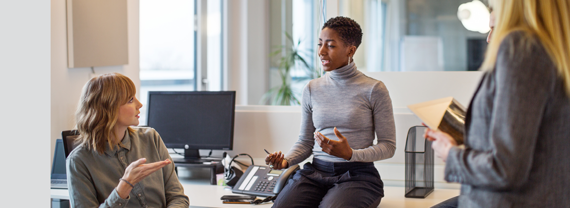 Mature business professional having a discussing with her team in office. Business group having a meeting in new office.