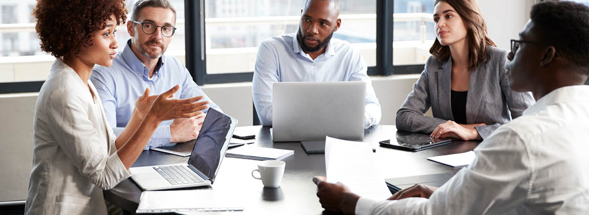 Millennial black businesswoman addressing colleagues at a corporate business meeting, close up